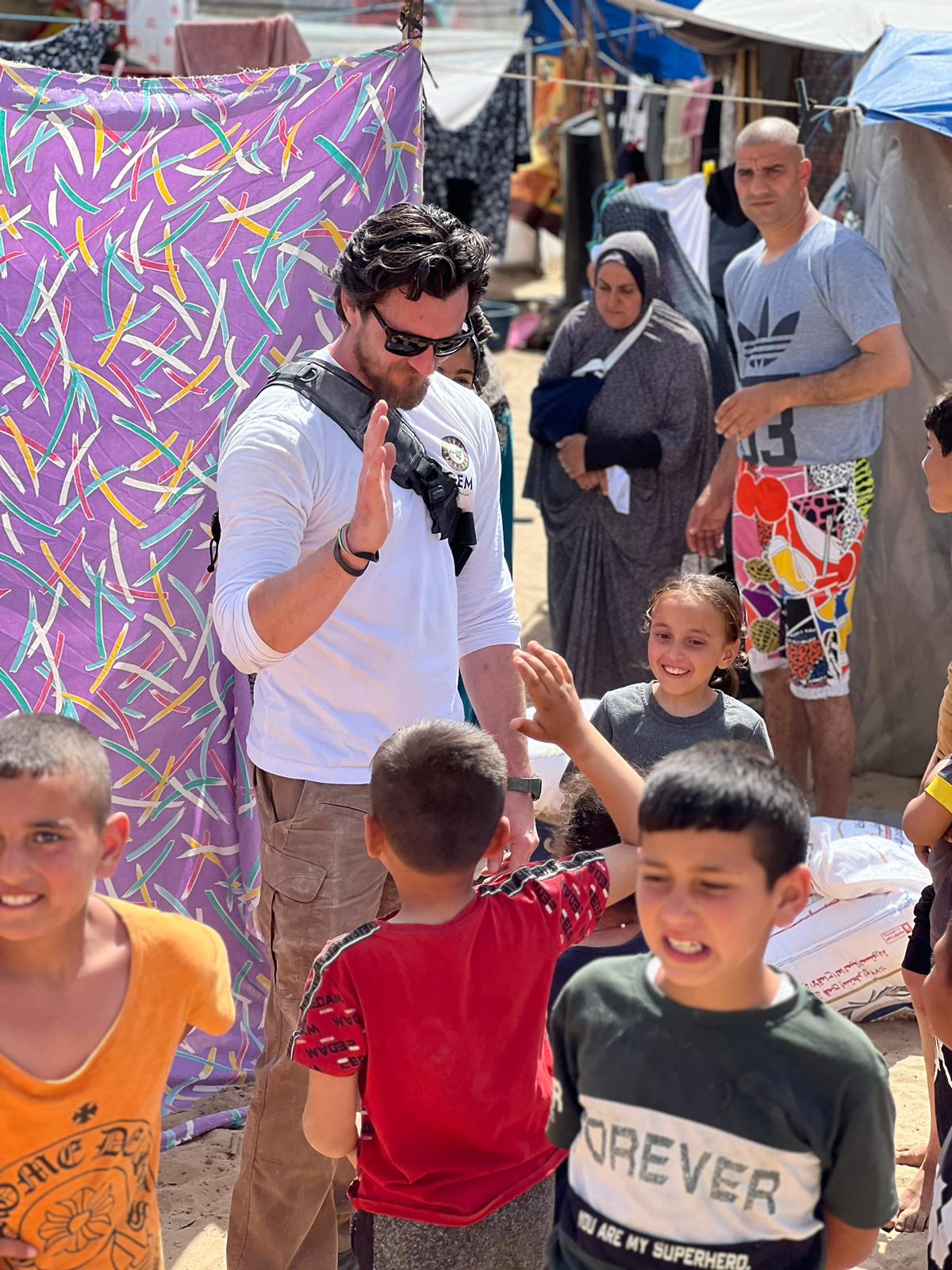 High-fiving children in a camp in Gaza