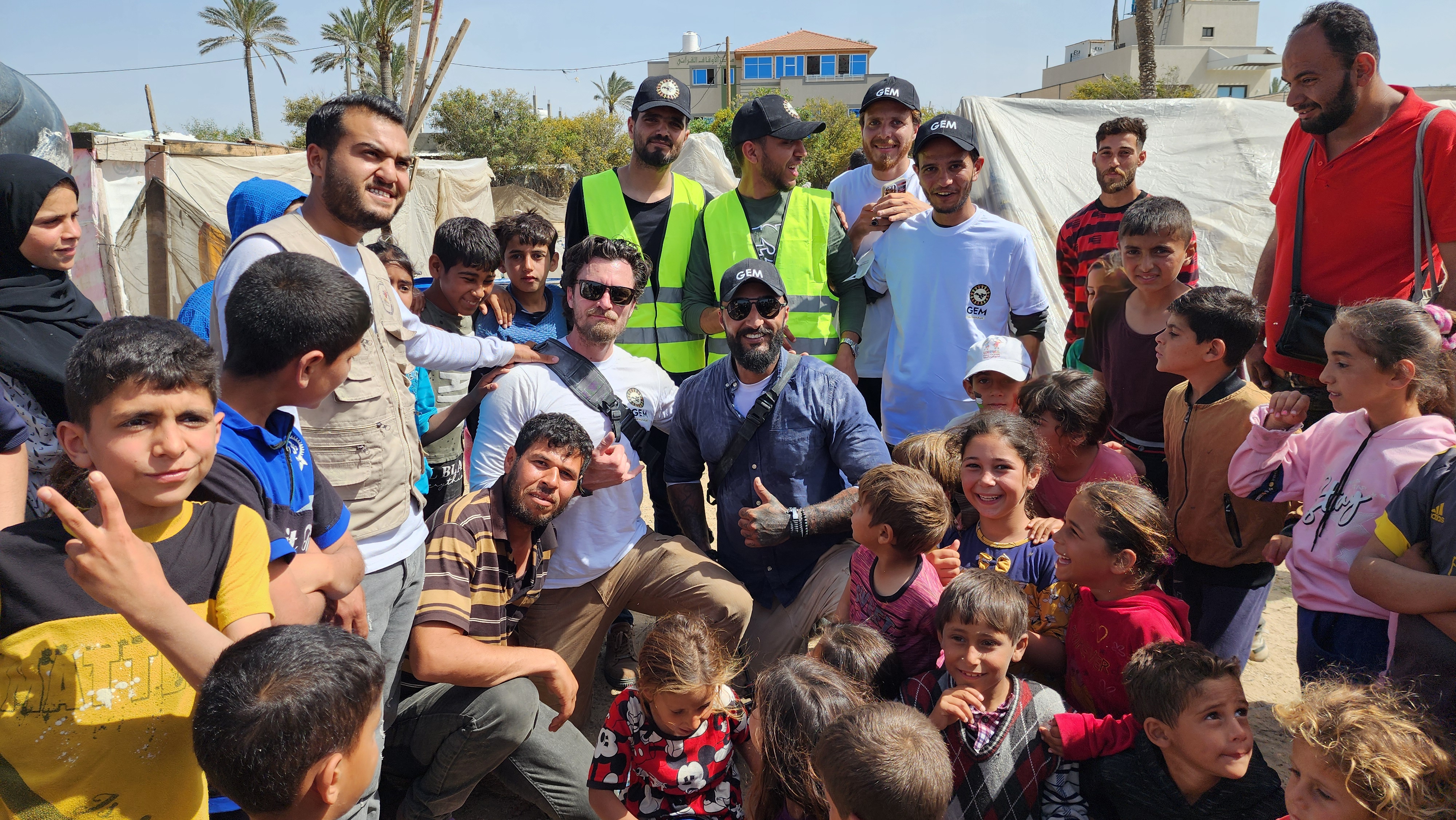 Aid workers surrounded by children in Gaza