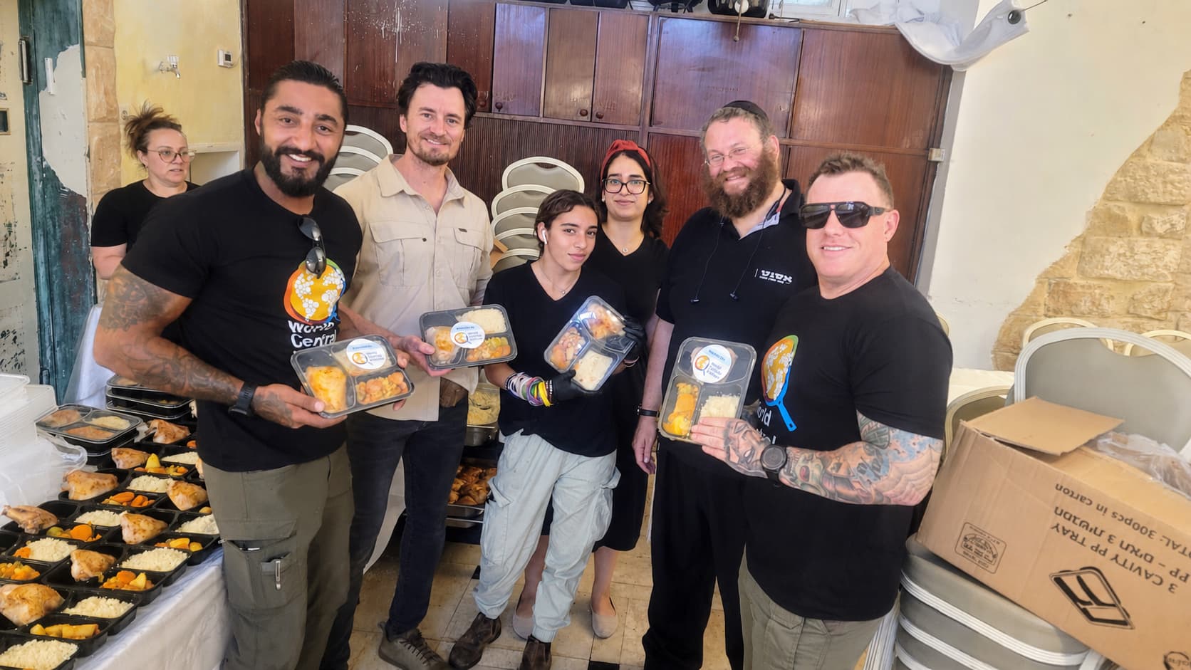Team holding food trays with World Central Kitchen in Israel