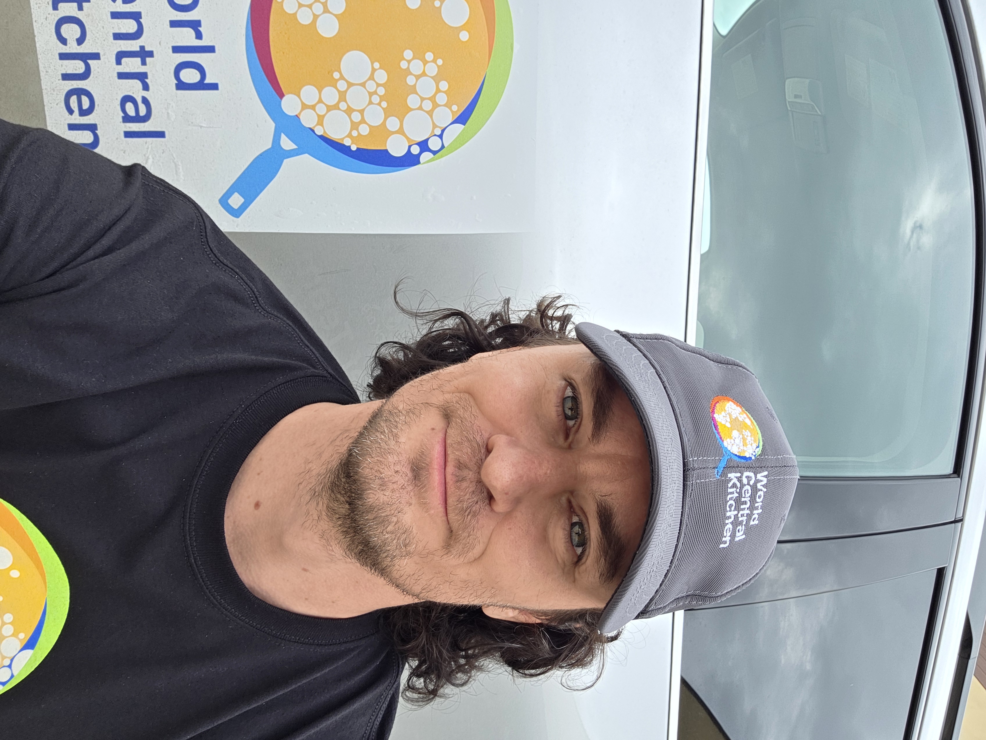 Team member sitting by a car in Kerrville
