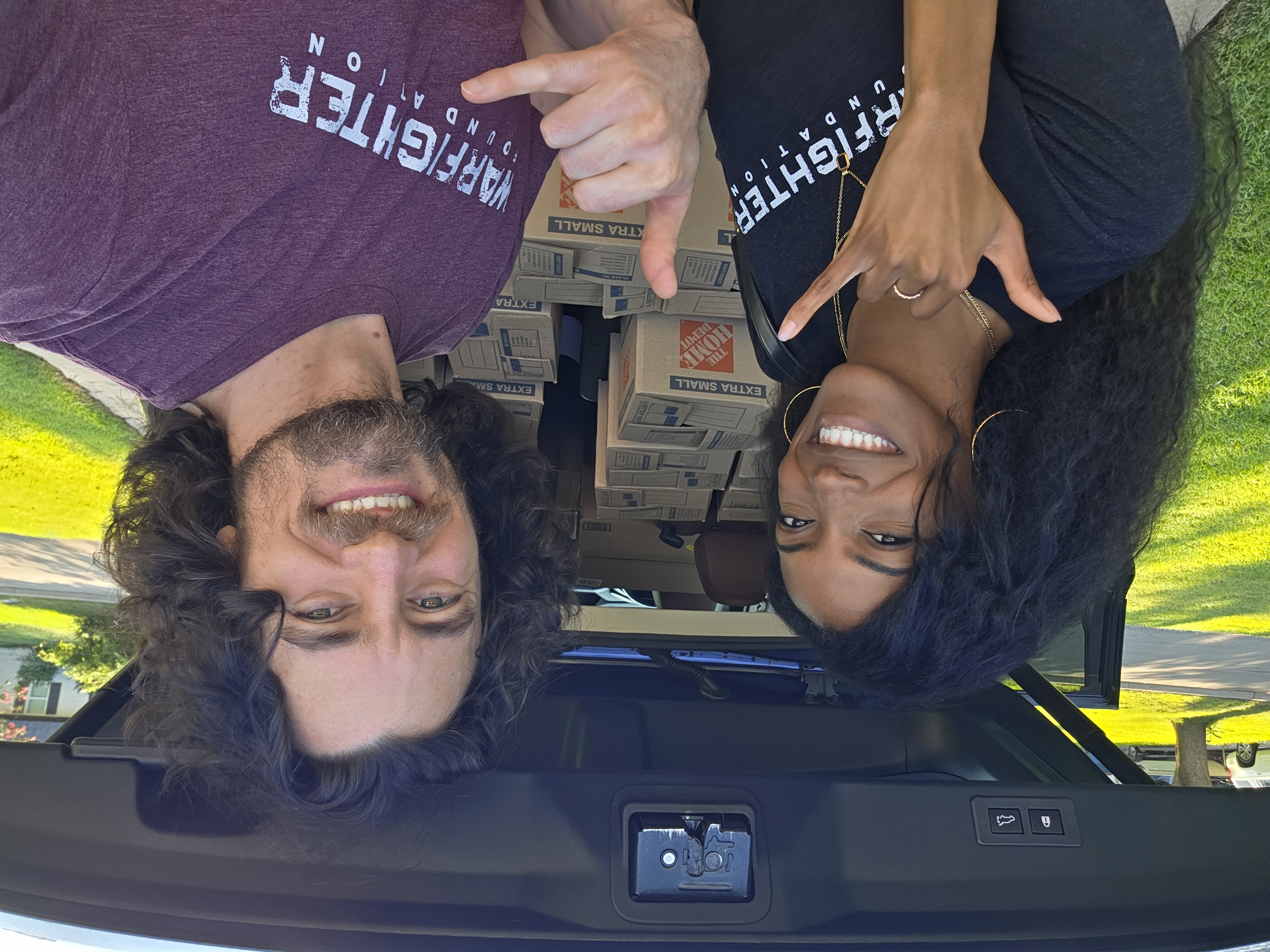 Team standing by car at Serenity Village