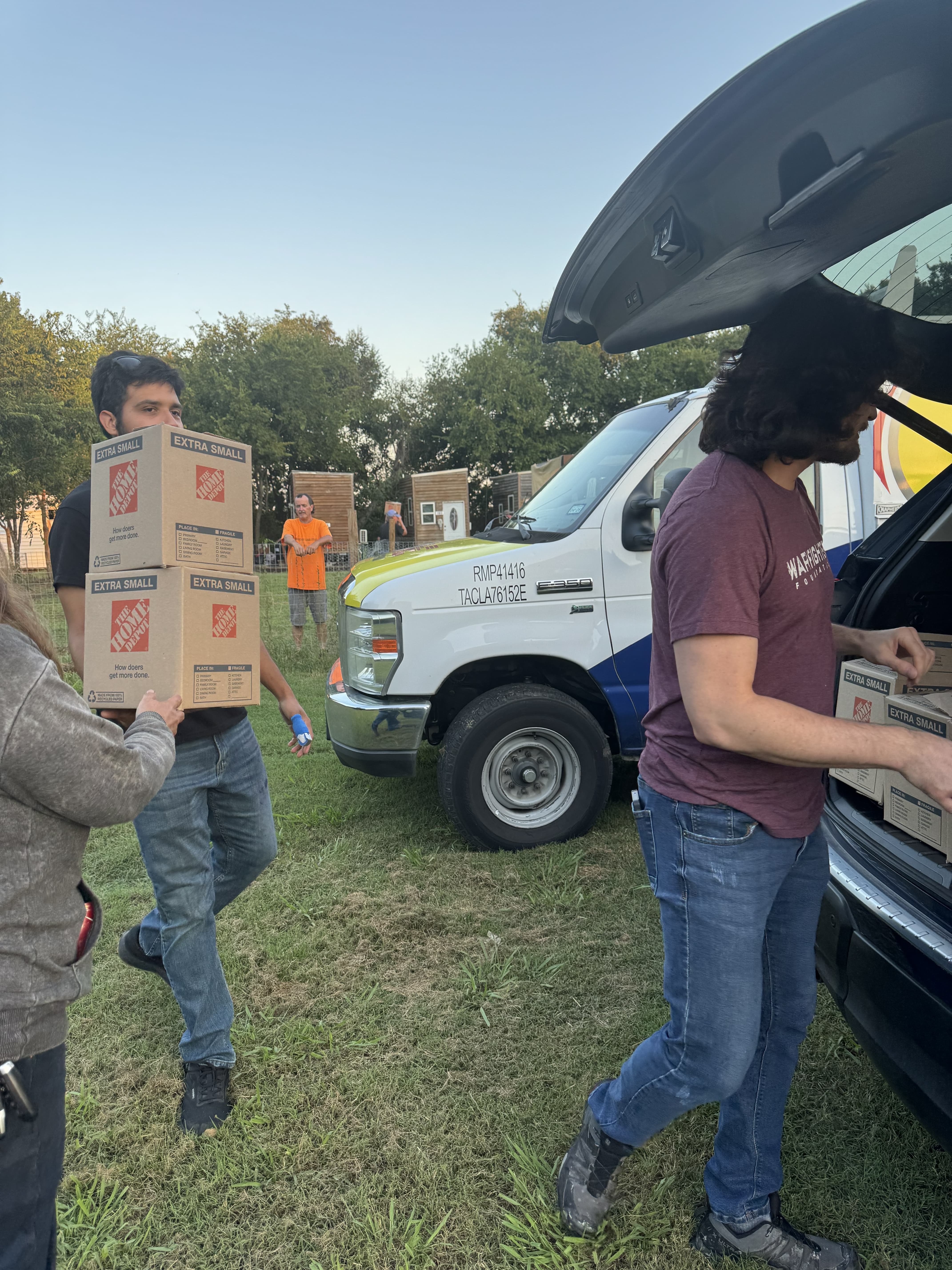 Handing care package boxes to Veterans at Serenity Village
