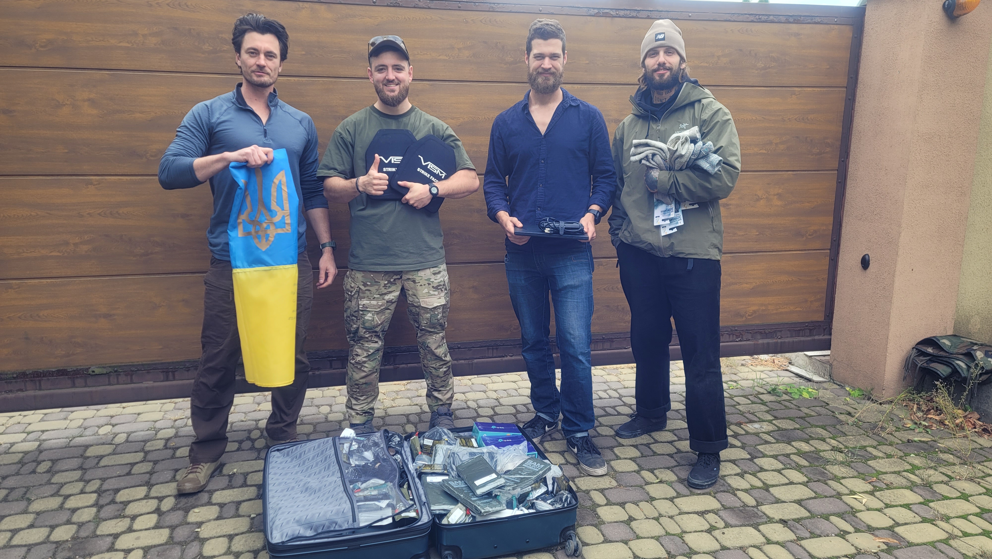 Warfighter Foundation team with flag and supplies in Ukraine